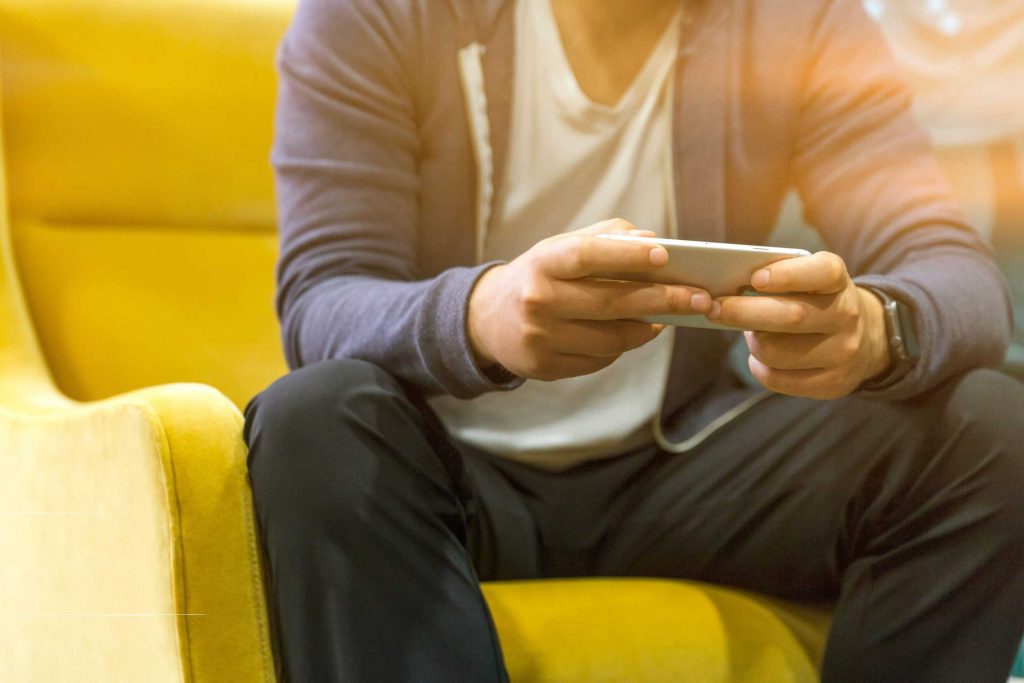 Man reading mobile phone Gold Coast Psychologist